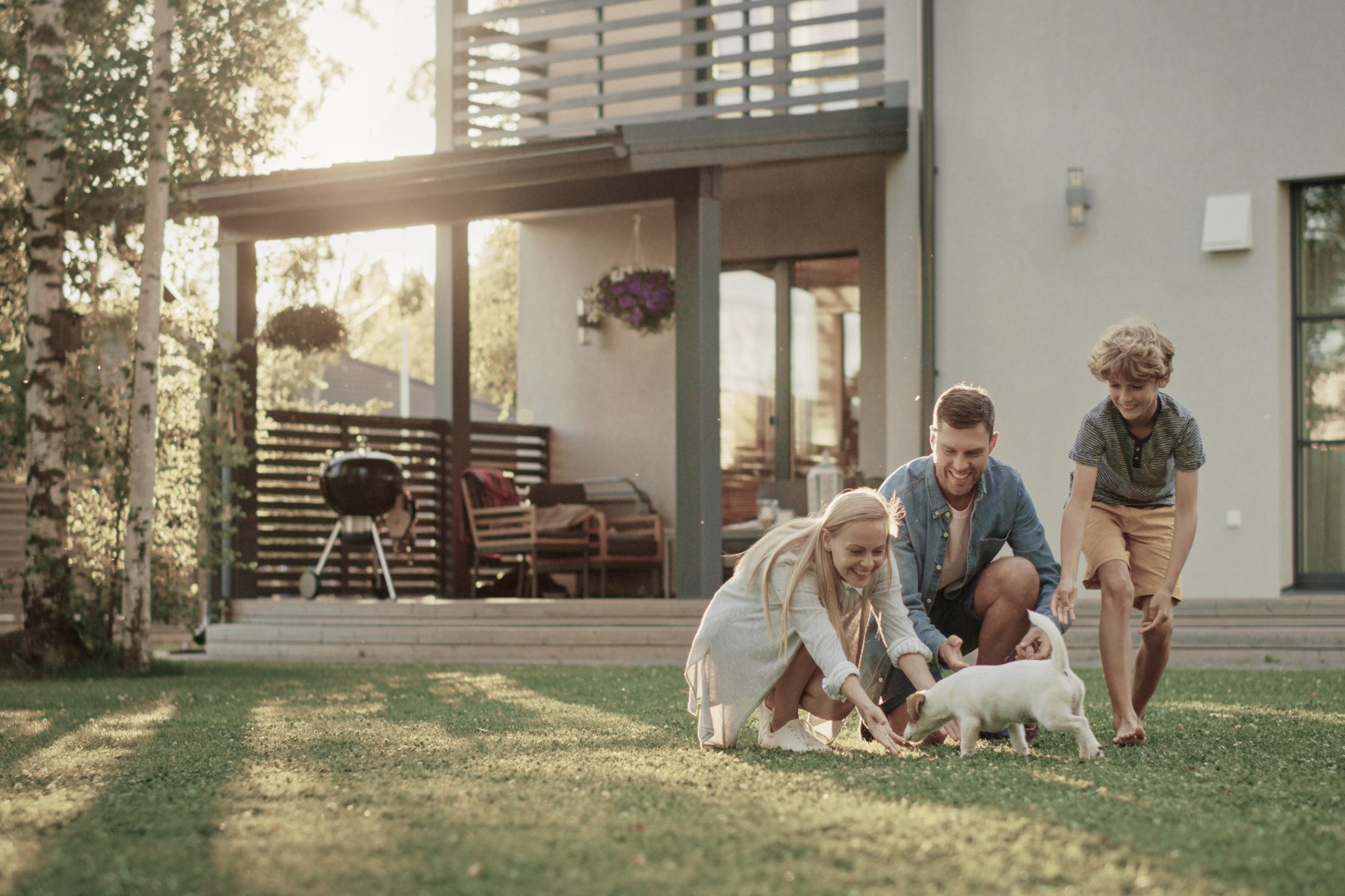 Personal Insurance - A family playing with their dog in the back yard.