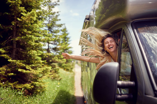 Recreational insurance in MN - A woman leaning out the passenger window of an RV.